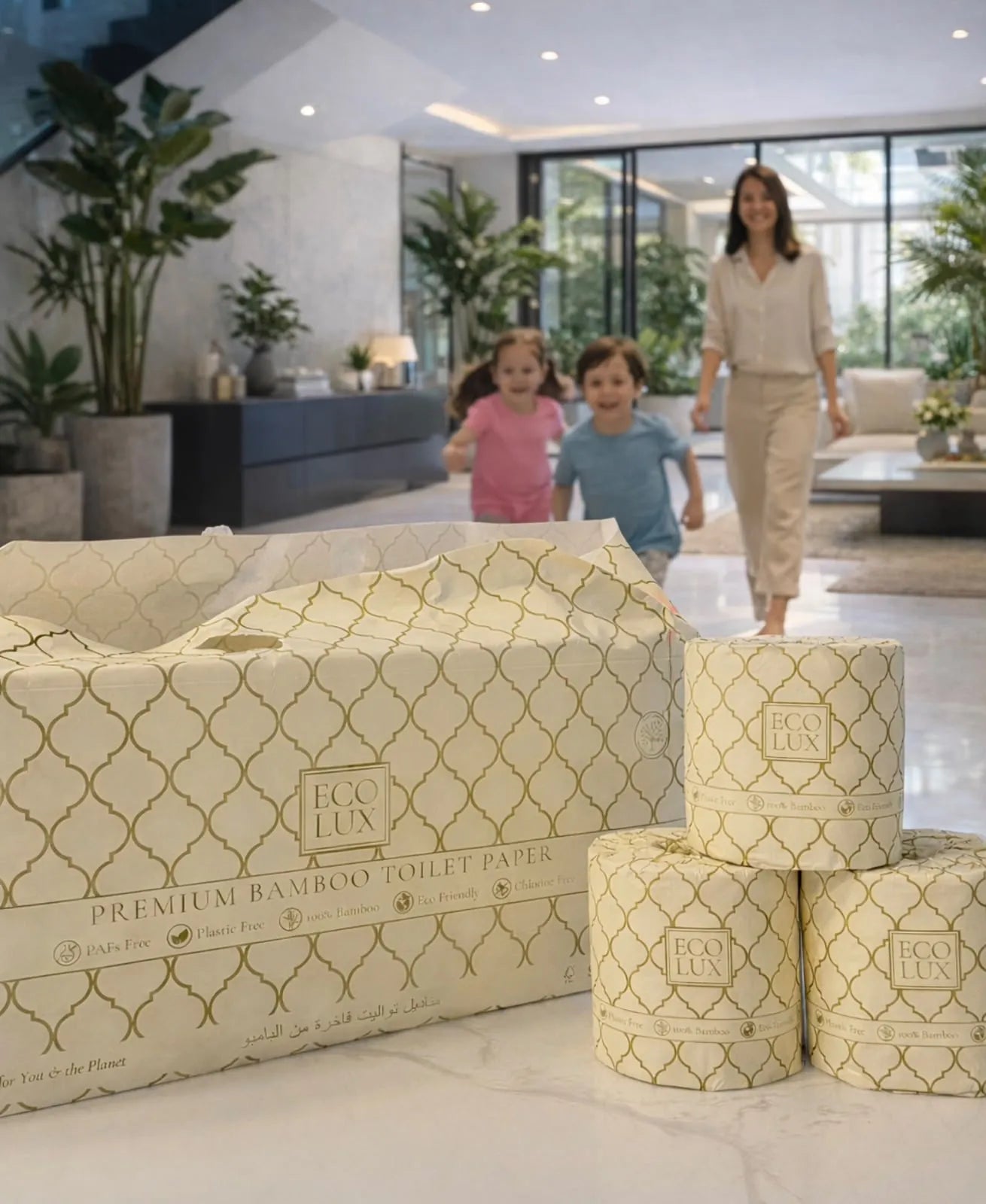 A mother and two children run into a bright villa living room towards an open Eco Lux case and three wrapped rolls