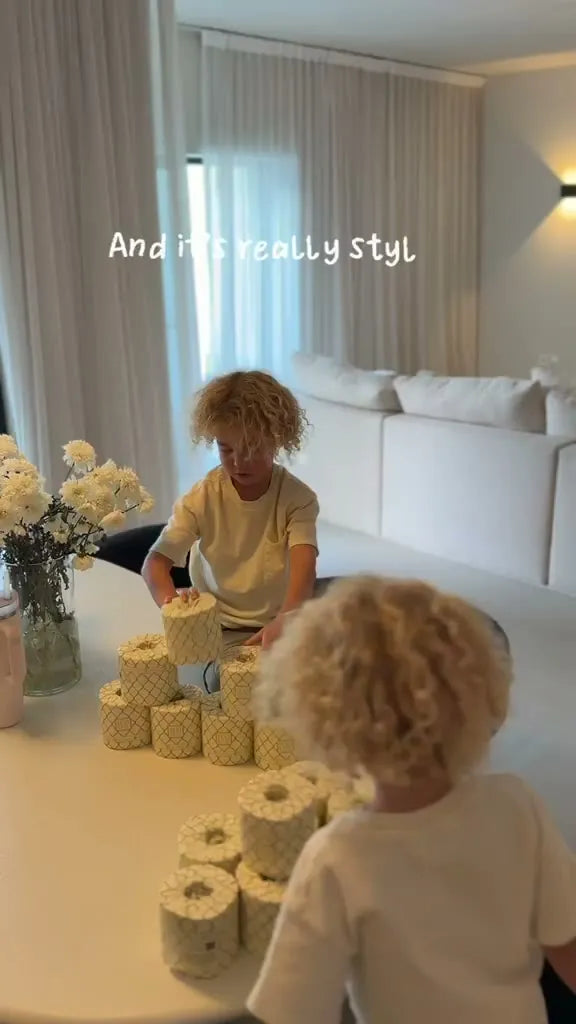 A mum and her children unpack Eco Lux and build towers from the rolls.