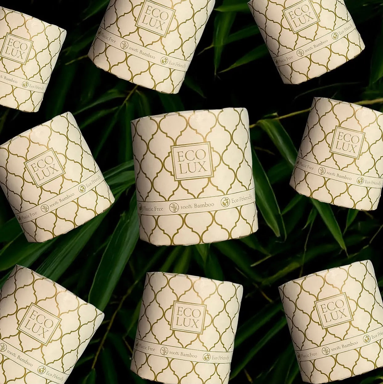 Wrapped Eco Lux rolls scattered over dark bamboo leaves