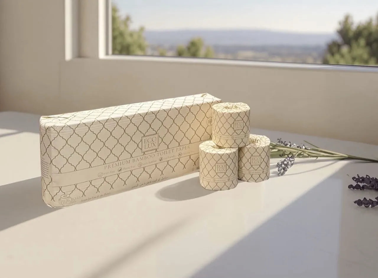 An Eco Lux case and three rolls on a white sill in soft morning light, hills beyond the window
